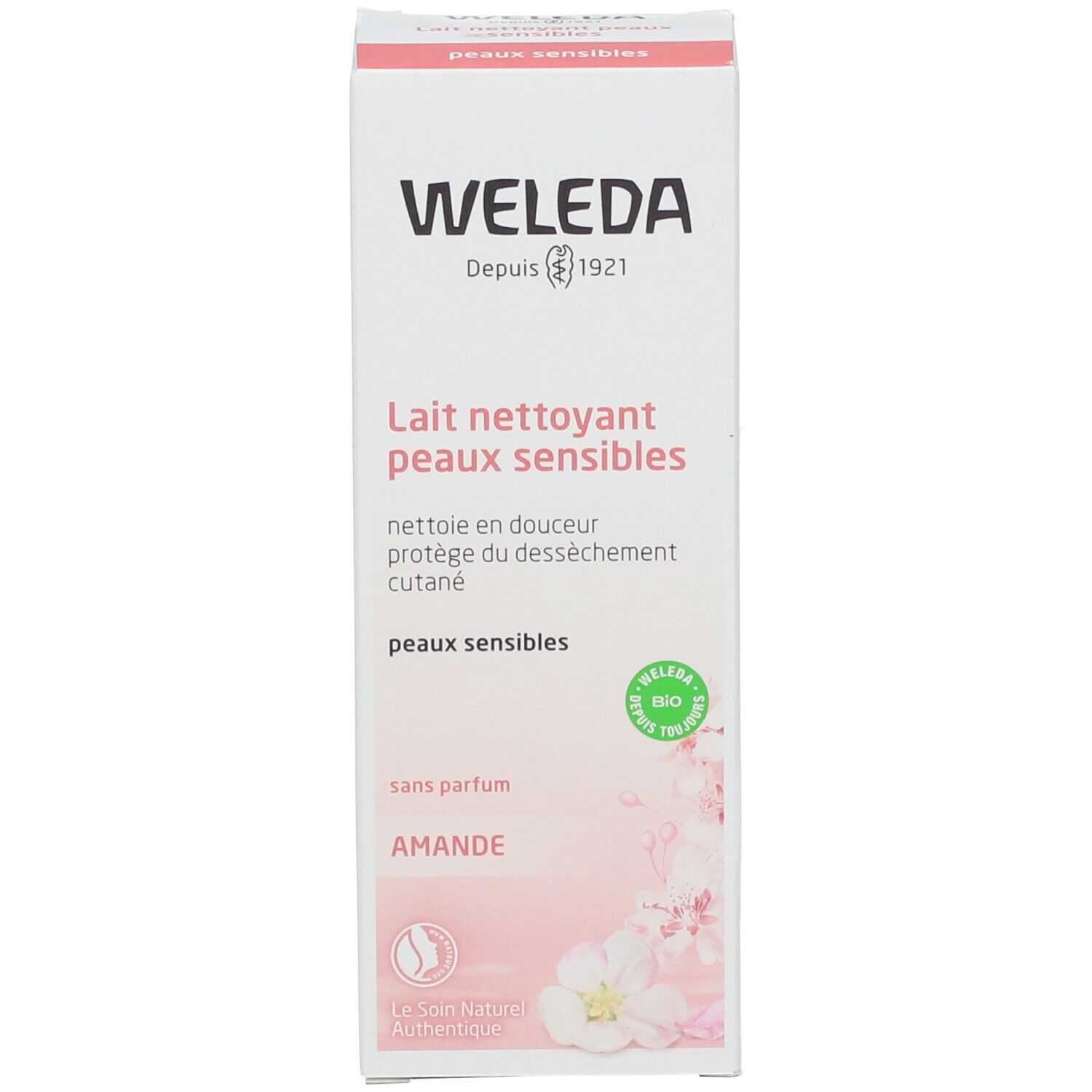 Karton mit Produkttext und floralem Design. Schriftzug: WELEDA, Lait nettoyant peaux sensibles, sans parfum, Amande. Logo: Bio.