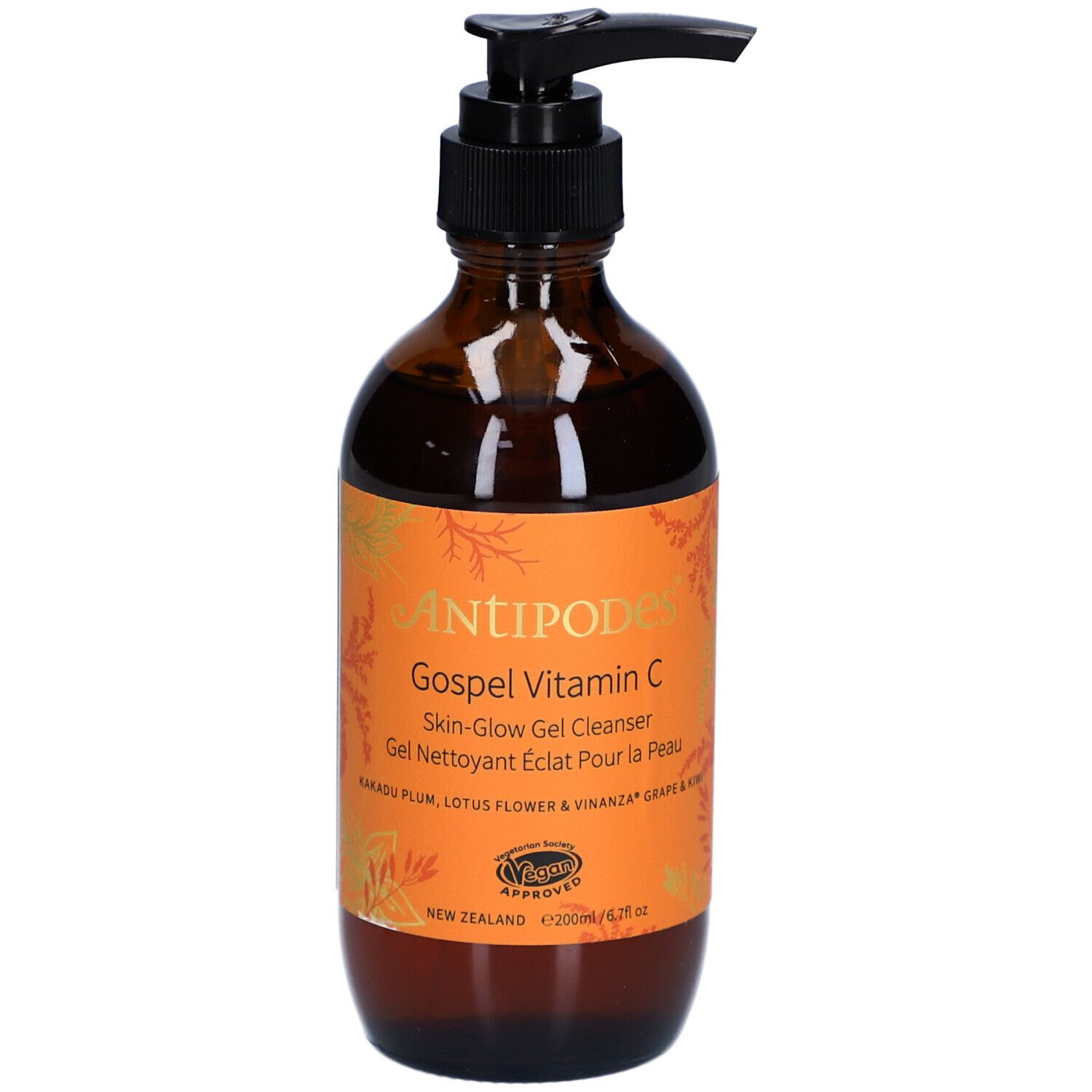 Bruine glazen fles met zwarte pomp. Oranje etiket met productnaam en tekst. Vegan certificering.