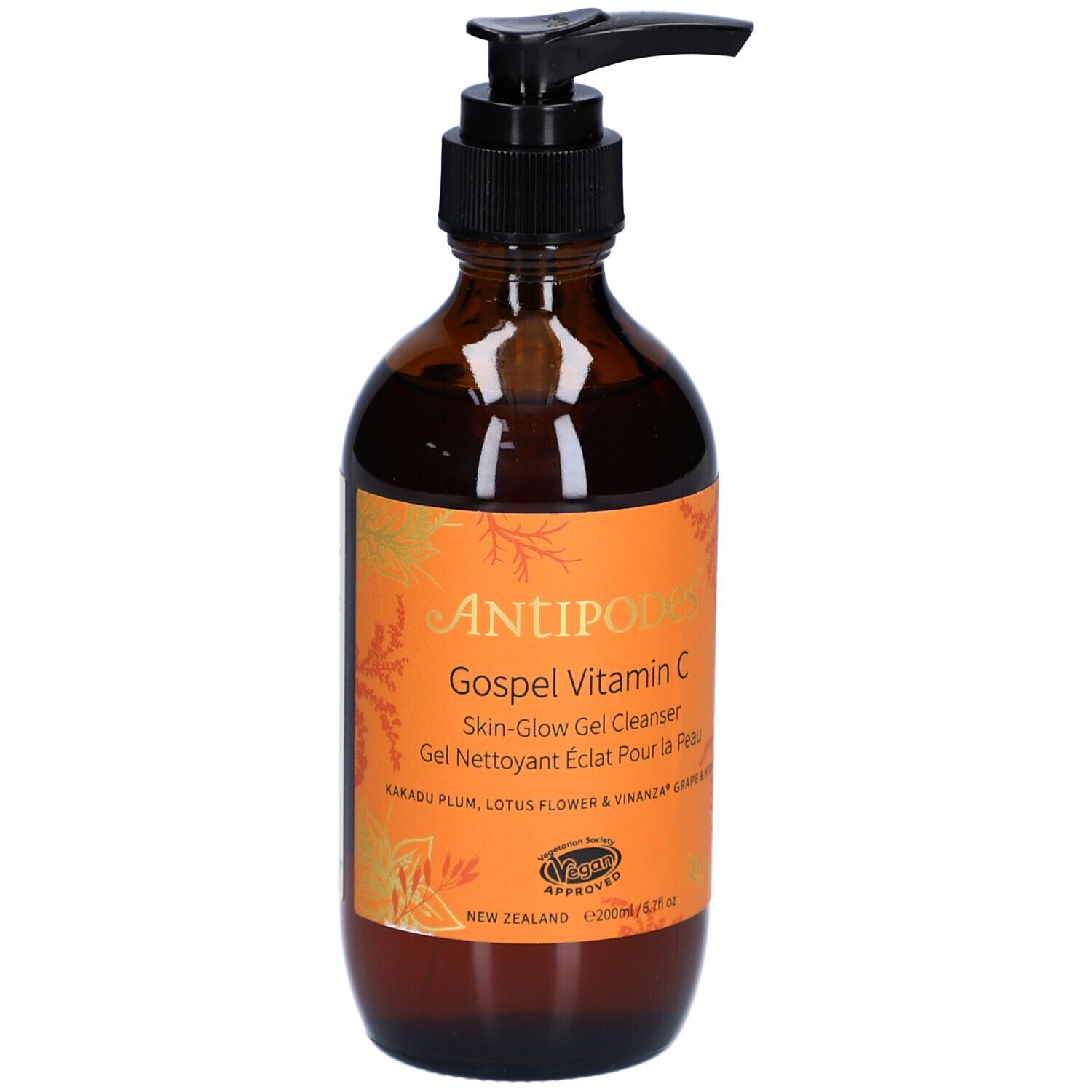 Bruine glazen fles met zwarte pomp. Oranje etiket met productnaam en tekst. Vegan certificering.