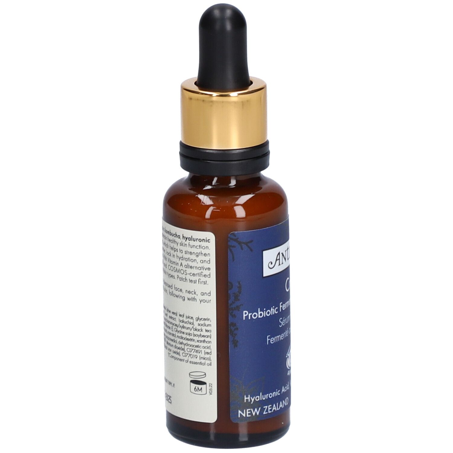 Braune Glasflasche mit goldener Kappe und Pipette. Aufkleber mit Produktinformationen. Vegan-Siegel.