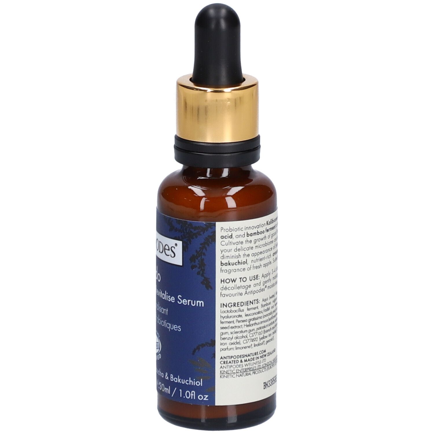 Braune Glasflasche mit goldener Kappe und Pipette. Aufkleber mit Produktinformationen. Vegan-Siegel.
