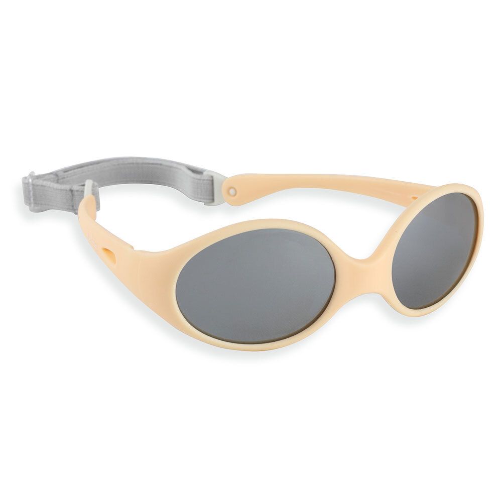 Lunettes de soleil beiges avec verres gris et bandeau gris. Design ovale.