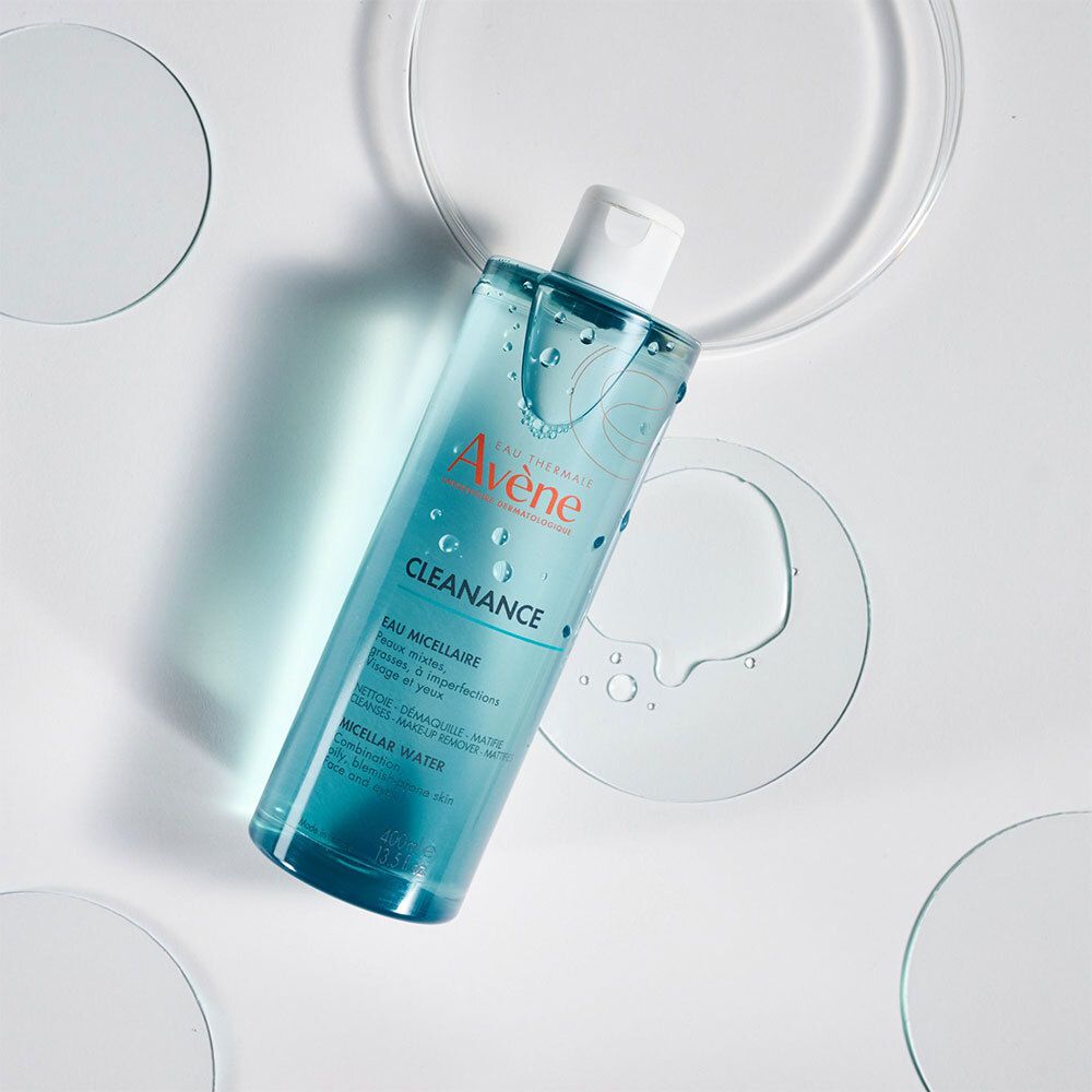 Avène Cleanance Mizellenwasser Flasche auf weißem Hintergrund mit Wasserringen. Produkt und Marke sichtbar.