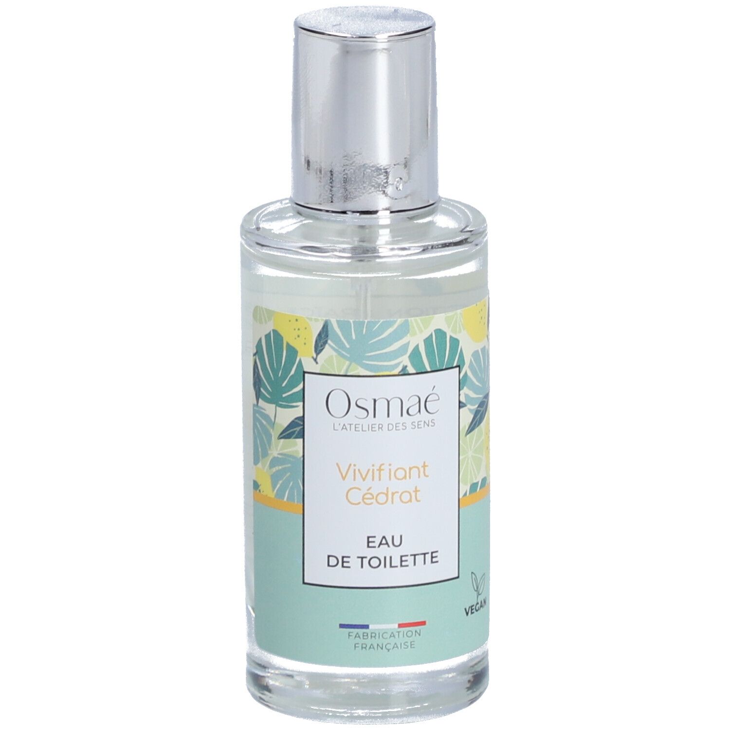 Flacon en verre avec vaporisateur argenté. Inscription: Osmaé, Vivifiant Cédrat, Eau de Toilette. Motif vert et jaune. Label Vegan.