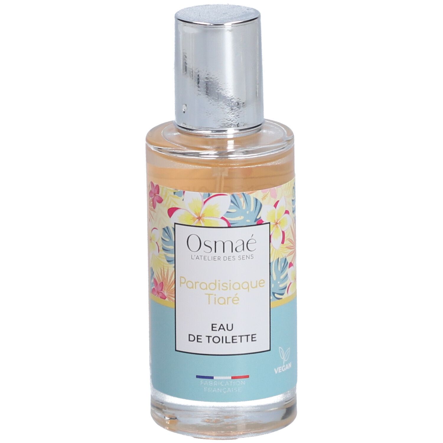 Parfümflasche mit floralem Design. Aufschrift: Osmaé, Paradisiaque Tiaré, Eau de Toilette. Silberner Sprühkopf.