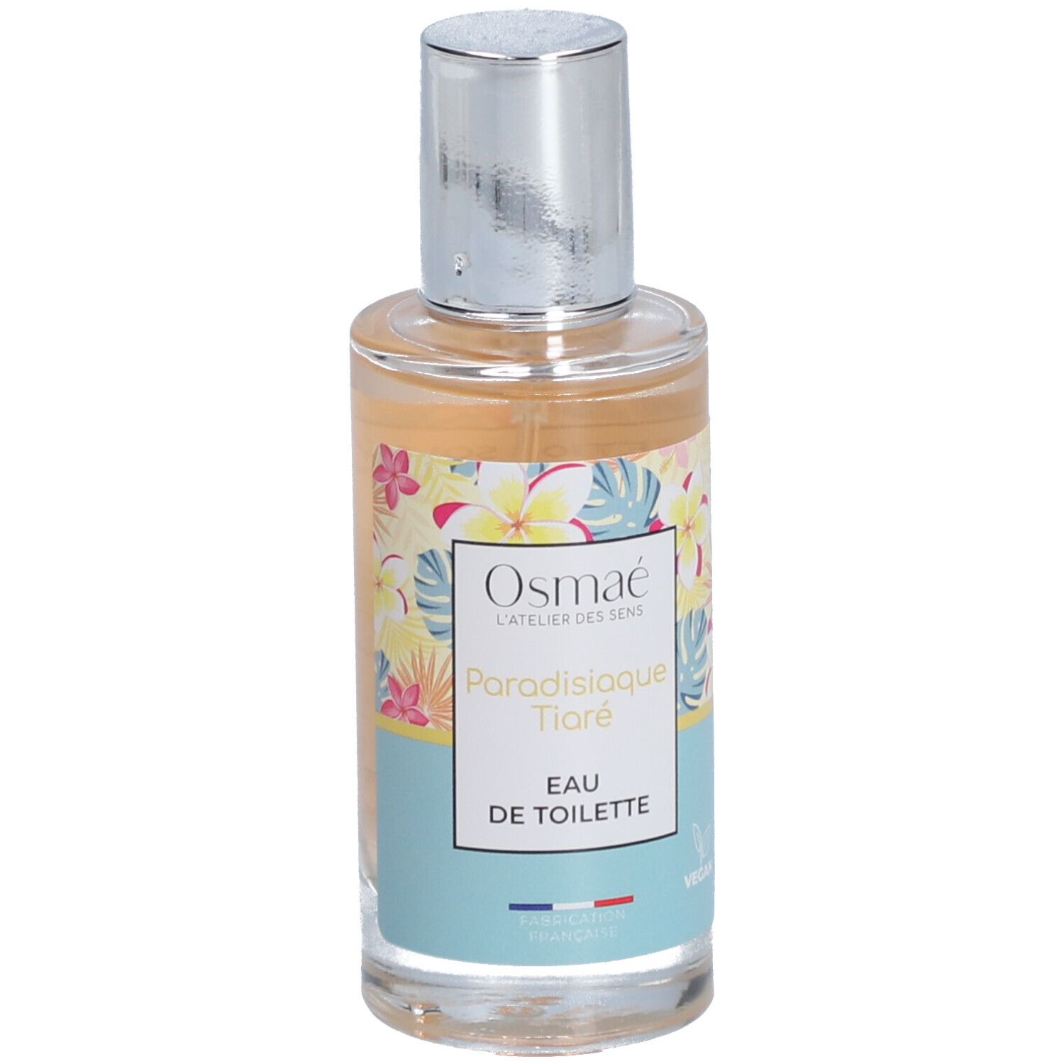 Parfümflasche mit floralem Design. Aufschrift: Osmaé, Paradisiaque Tiaré, Eau de Toilette. Silberner Sprühkopf.
