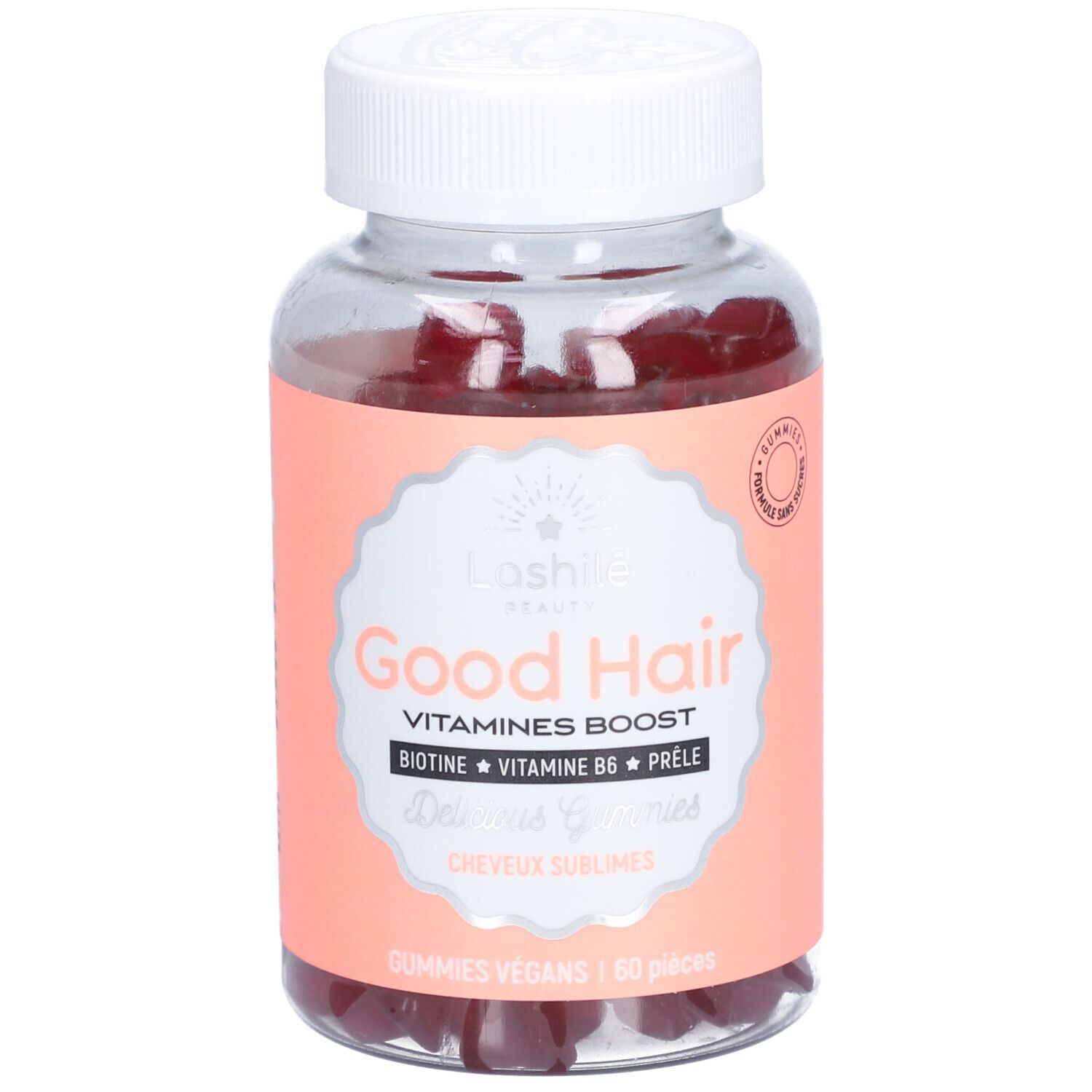 Flacon transparent avec gummies rouges. Étiquette "Good Hair" et ingrédients. Bouchon blanc.