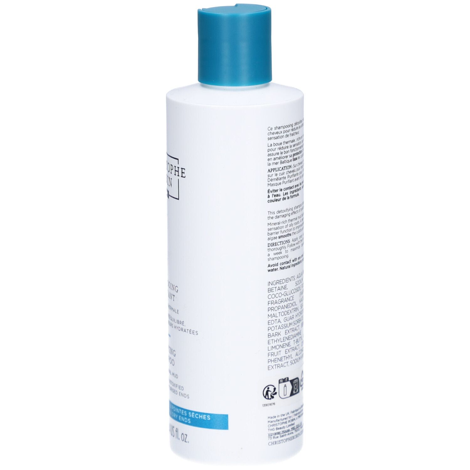 Weiße Flasche mit türkisfarbenem Verschluss. Enthält Shampoo für trockenes Haar.
