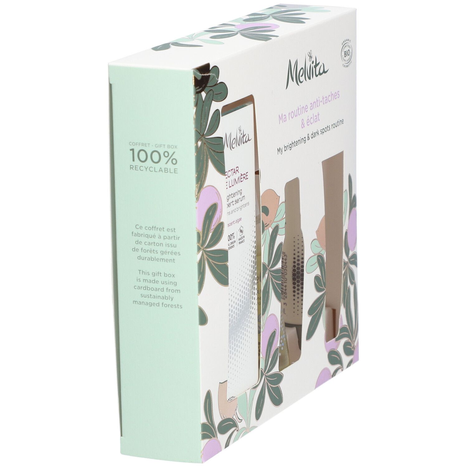 Coffret cadeau, vue latérale. Visible : sérum, flacon, crème. Texte : 100% recyclable. Motif floral.