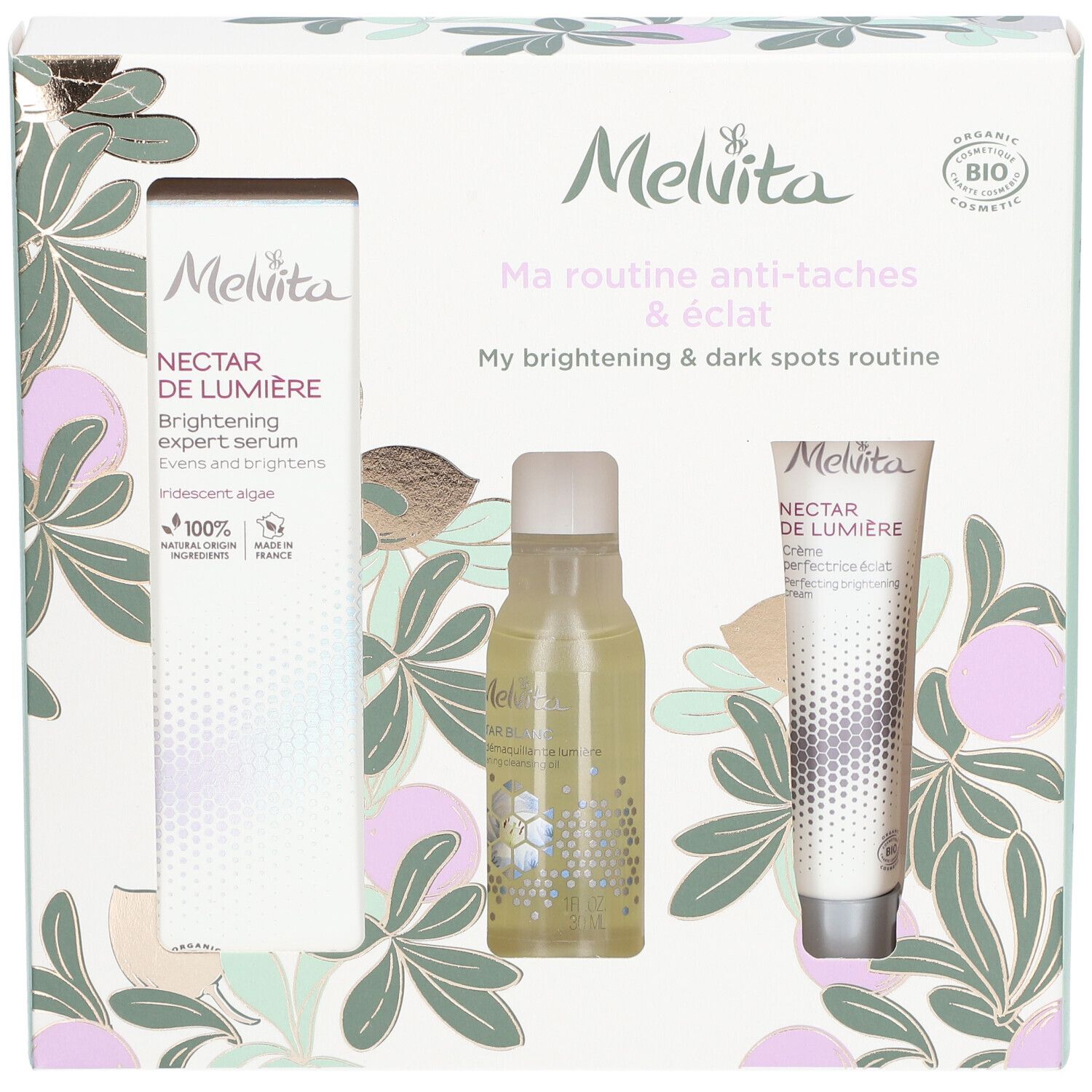 Coffret cadeau avec trois produits. Visible : sérum, flacon, crème. Emballage avec motif floral et logo de la marque.