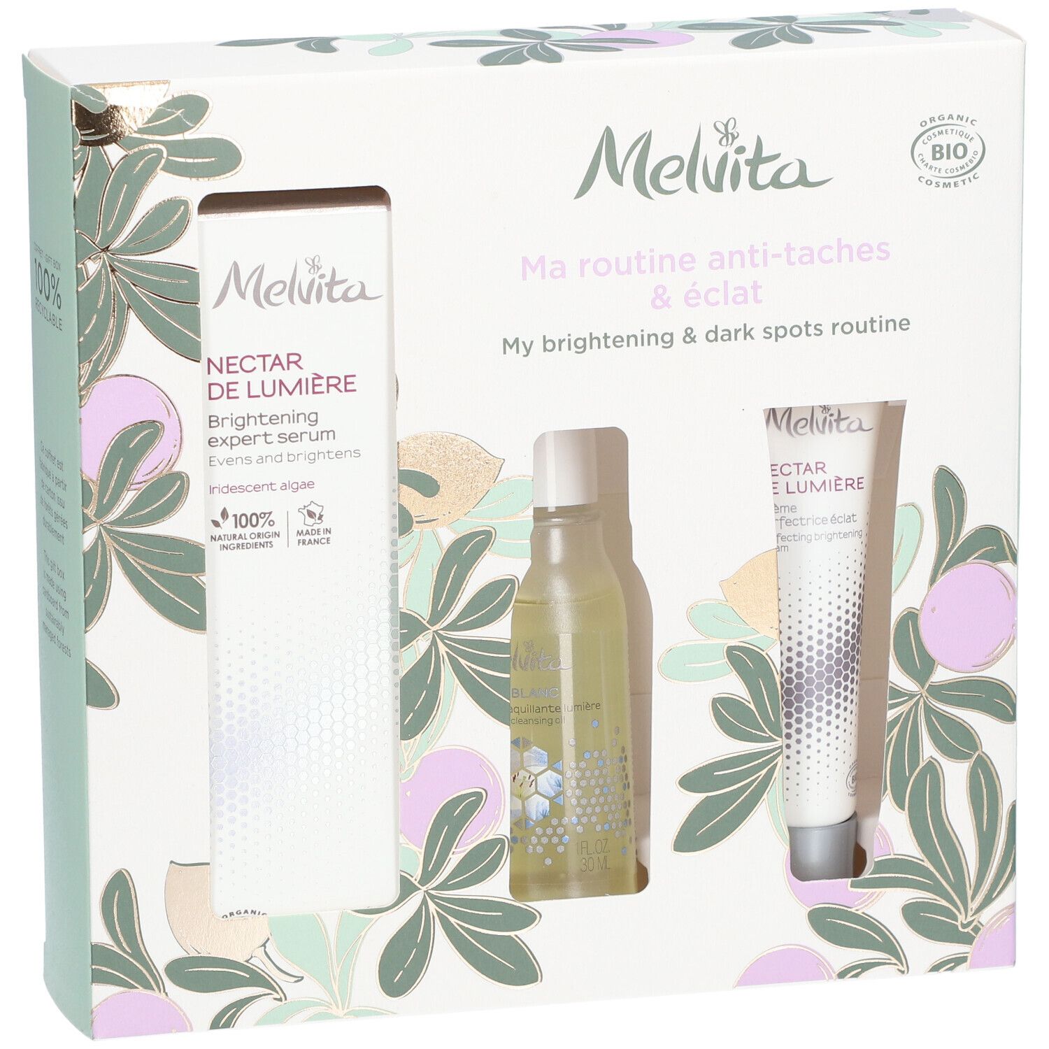 Coffret cadeau avec trois produits. Visible : sérum, flacon, crème. Emballage avec motif floral et logo de la marque.