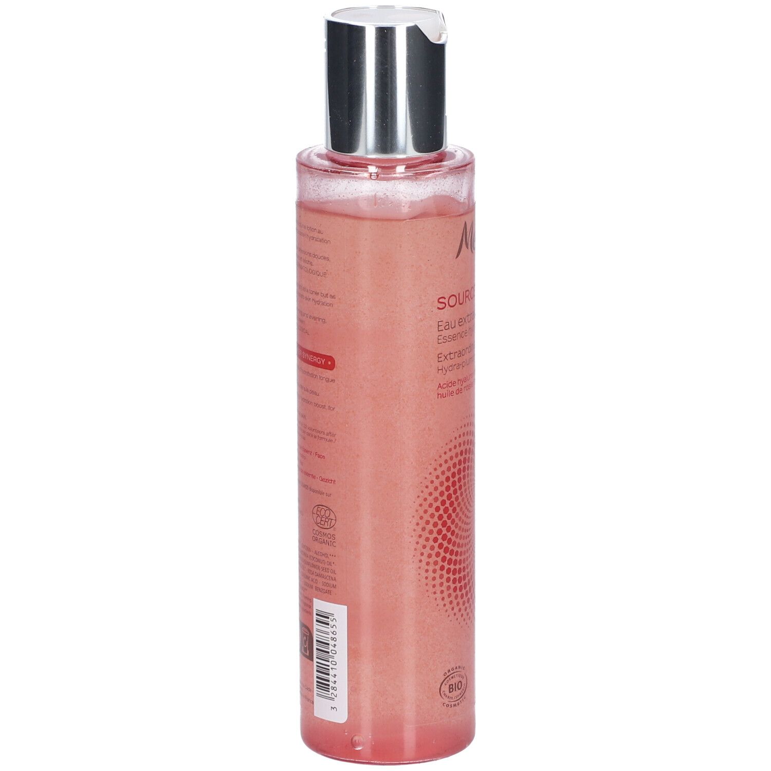 Dos d'un flacon transparent, liquide rose. Bouchon argenté. Texte sur l'étiquette.