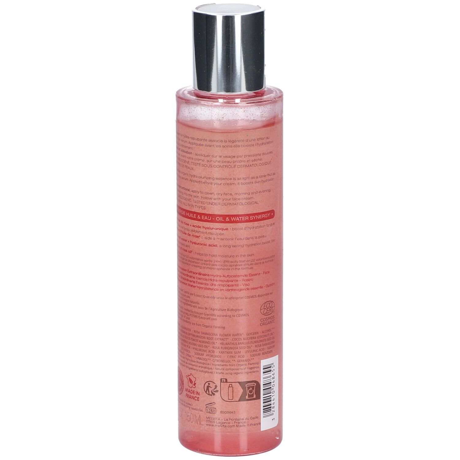 Dos d'un flacon transparent, liquide rose. Bouchon argenté. Texte sur l'étiquette.