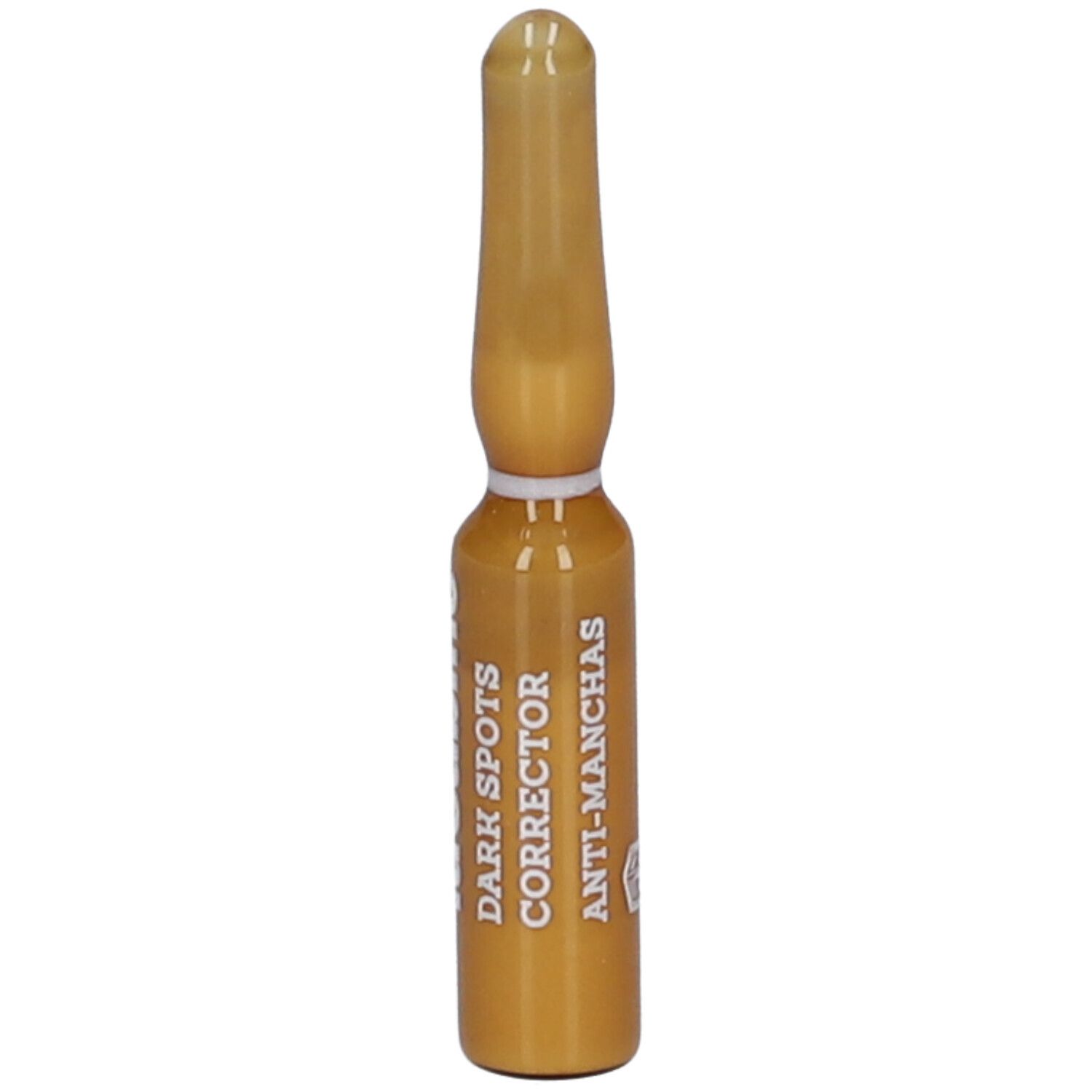 Ampoule dorée avec les inscriptions "DARK SPOTS CORRECTOR" et "ANTI-MANCHAS".