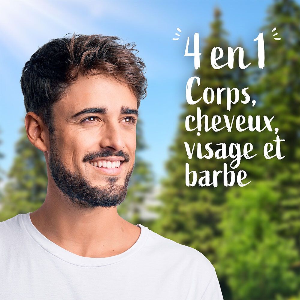Een man glimlacht voor een achtergrond met bomen. Tekst: '4 en 1 Corps, cheveux, visage et barbe'.