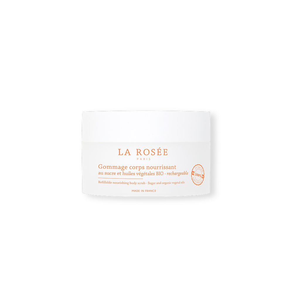 Pot blanc avec impression rose. Texte: Gommage corps nourrissant, sucre et huiles végétales. Sceau: 100% naturel.