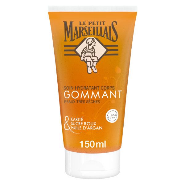 Tube orange. Marque et logo visibles. Texte: Soin Hydratant Corps Gommant, Peaux Très Sèches. Ingrédients: Karité, sucre roux, huile d'argan.