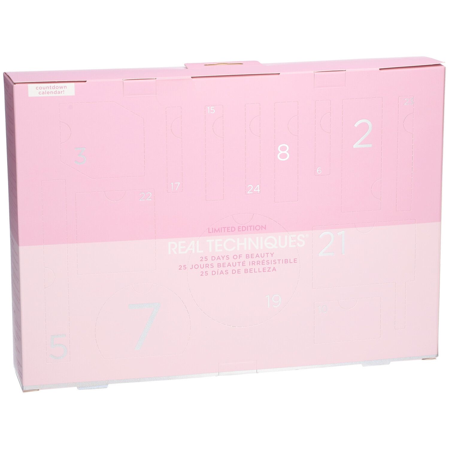 Rosa Adventskalender-Box mit silbernen Zahlen. "REAL TECHNIQUES" und "25 Tage Schönheit" Text.
