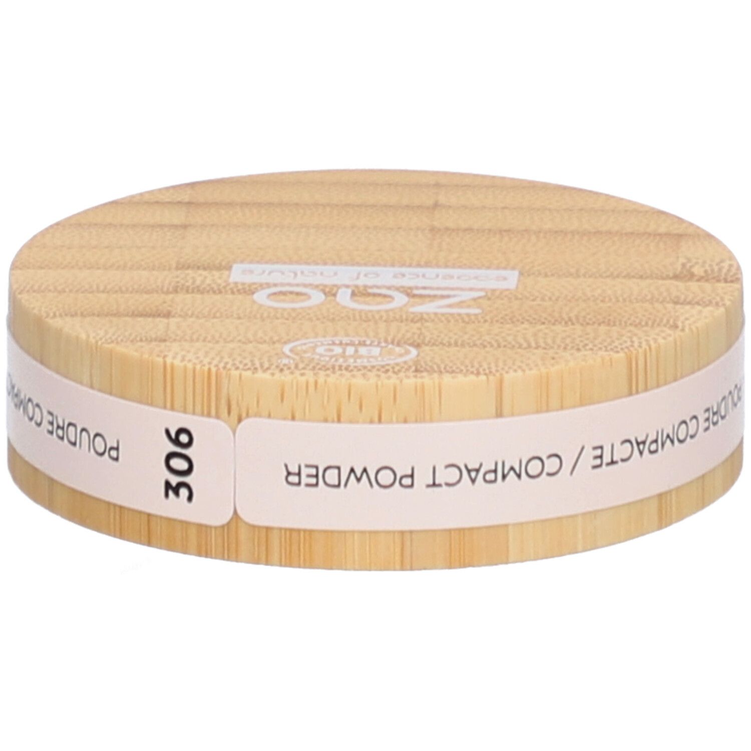 Ronde compactpoederdoos van hout. Opschrift: ZAO, essence of nature, 306, Poudre Compacte / Compact Powder.