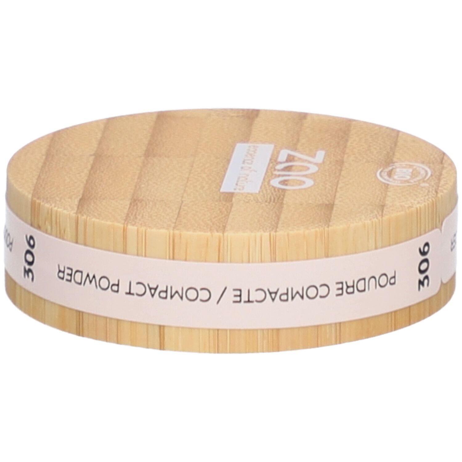 Ronde compactpoederdoos van hout. Opschrift: ZAO, essence of nature, 306, Poudre Compacte / Compact Powder.