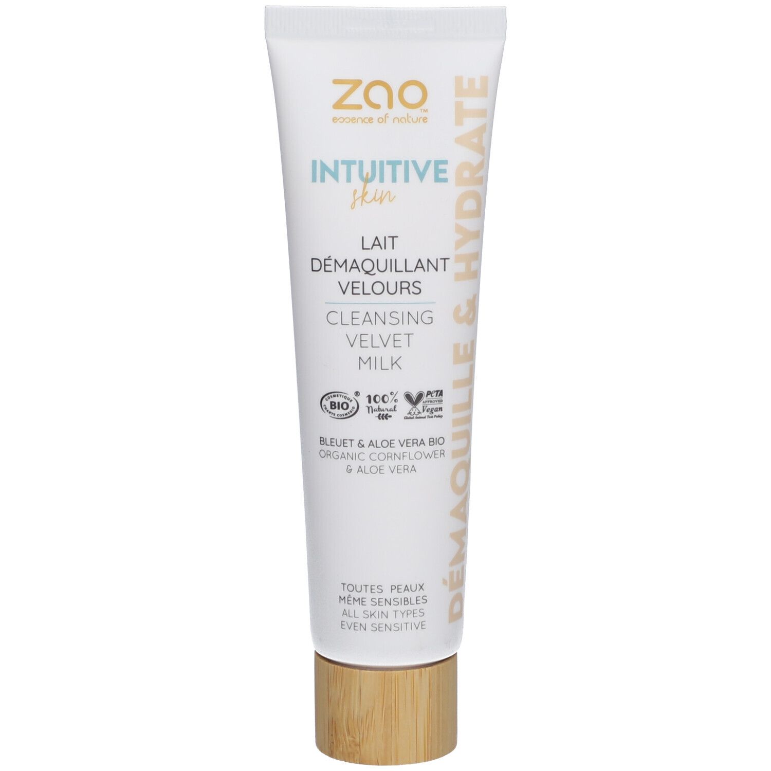 Witte tube met productnaam en logo. Houtkleurige dop. Tekst: Lait Démaquillant Velours, Intuitive Skin, Demaquille & Hydrate.