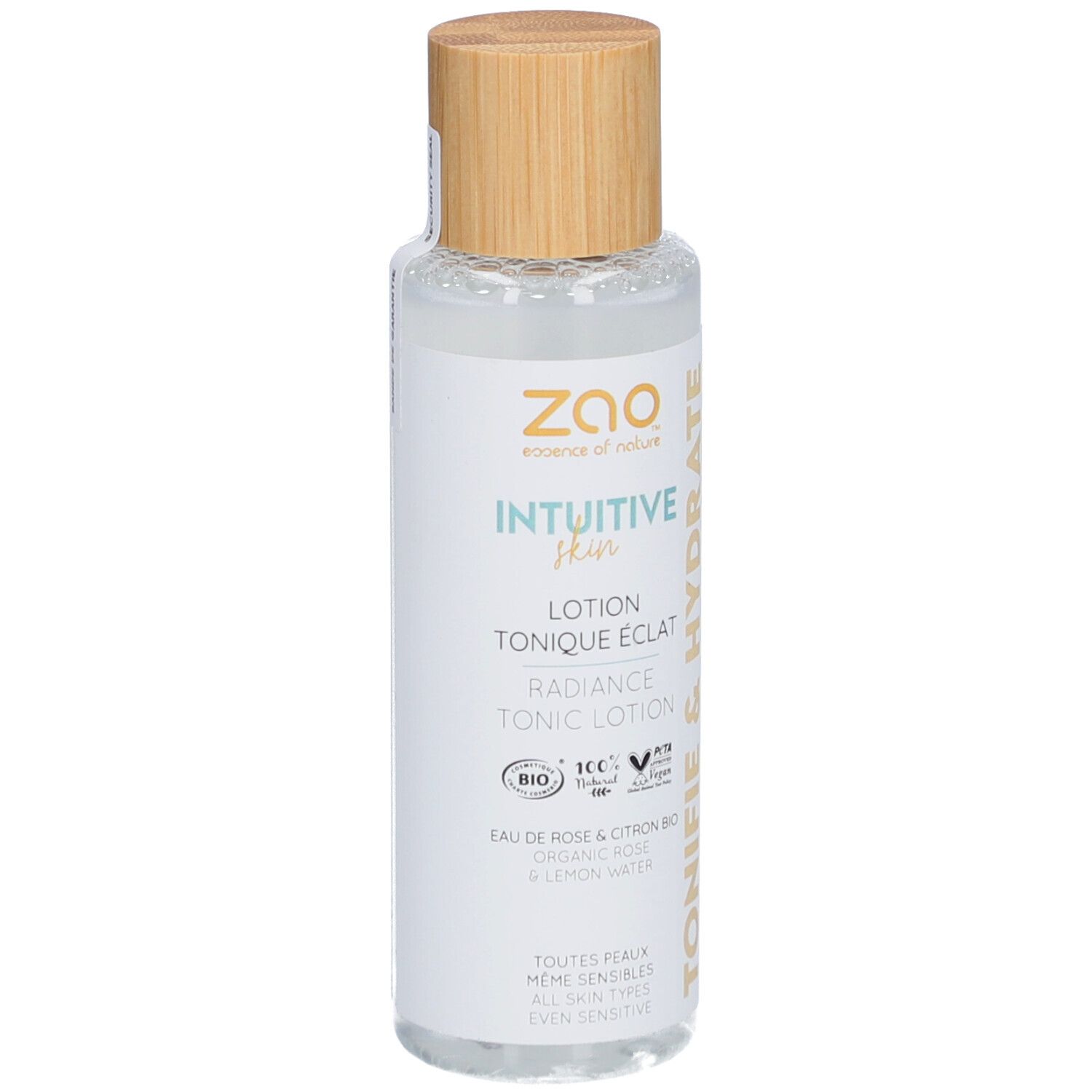 Transparante fles met houten dop. Opschrift: Intuitive Skin, Lotion Tonique Eclat, Radiance Tonic Lotion. Bio-certificering.