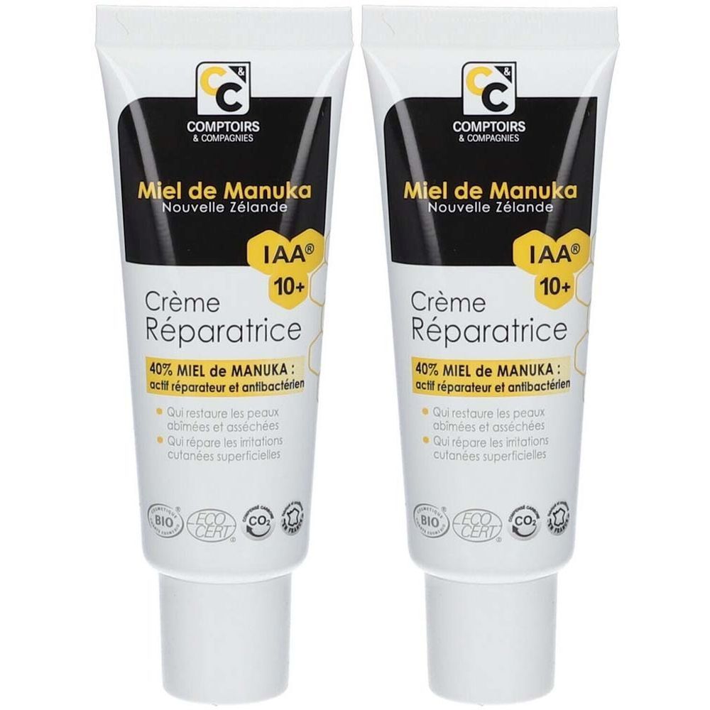 Zwei Tuben Creme. Aufschrift: Miel de Manuka, Crème Réparatrice, IAA 10+, Bio-Zertifizierung. Schwarze und weiße Verpackung.