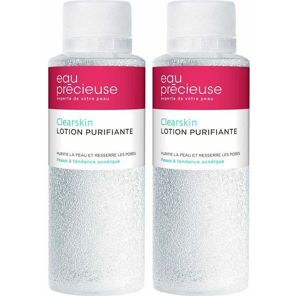 Deux flacons de lotion nettoyante. Inscription : Eau Précieuse, Clearskin, Lotion Purifiante. Étiquettes roses et blanches.