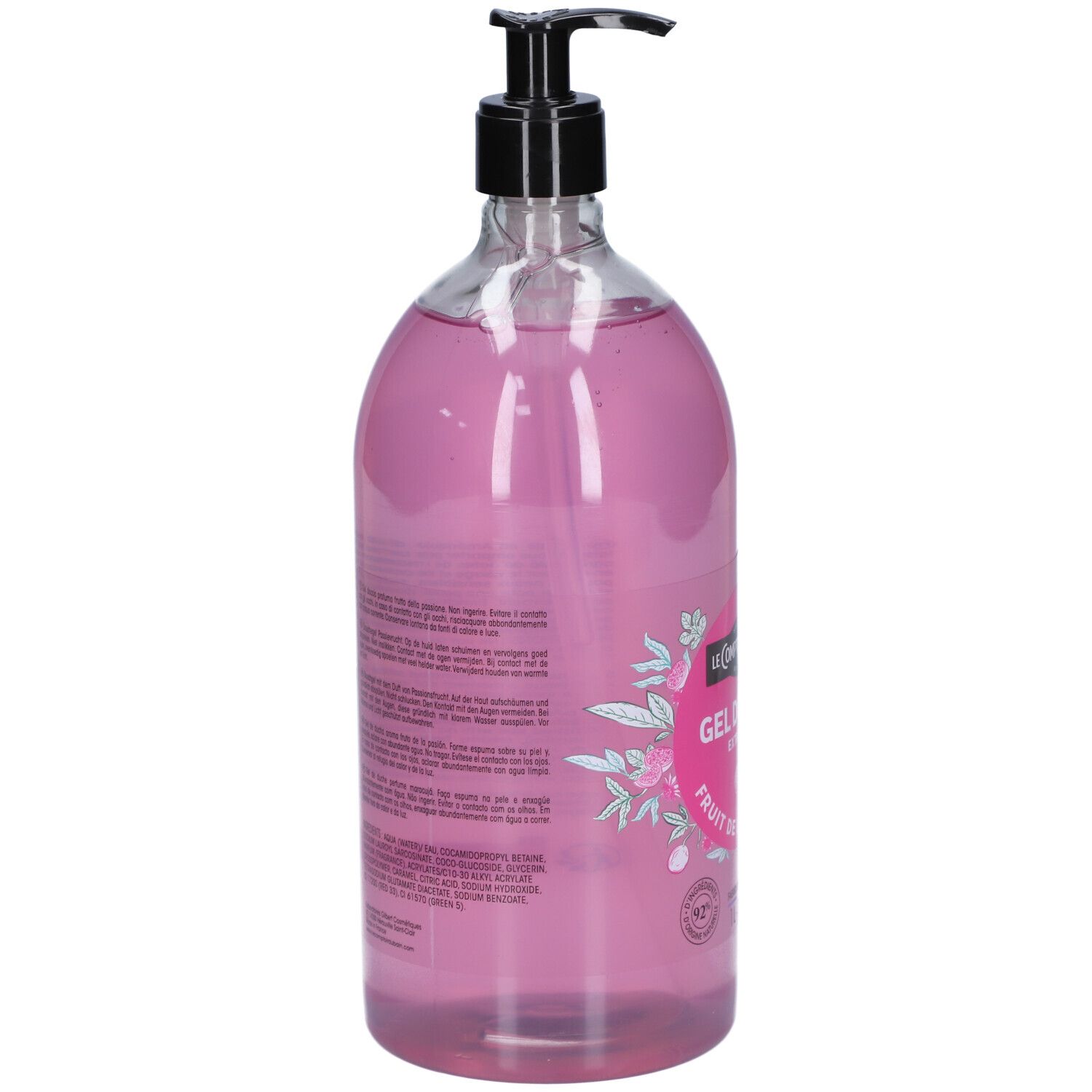 Vue arrière d'un flacon transparent avec liquide rose. Texte sur l'étiquette, pompe noire.
