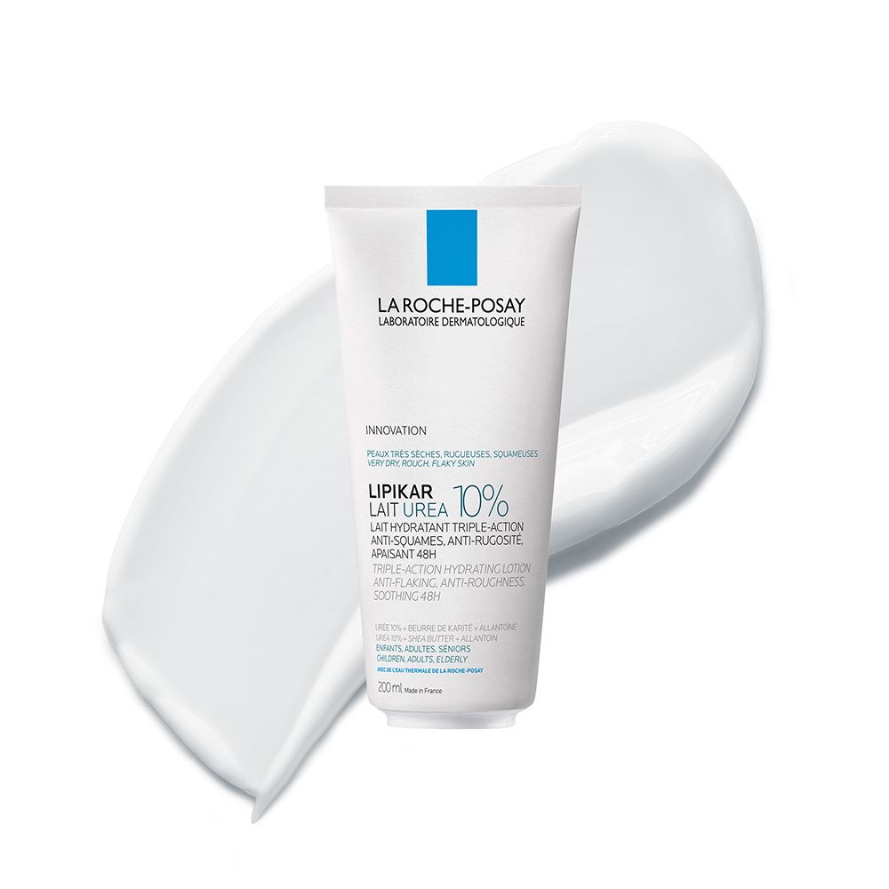 Tube blanc avec logo bleu. Texte : LA ROCHE-POSAY, LIPIKAR Lait Urée 10%. Sur fond de crème.