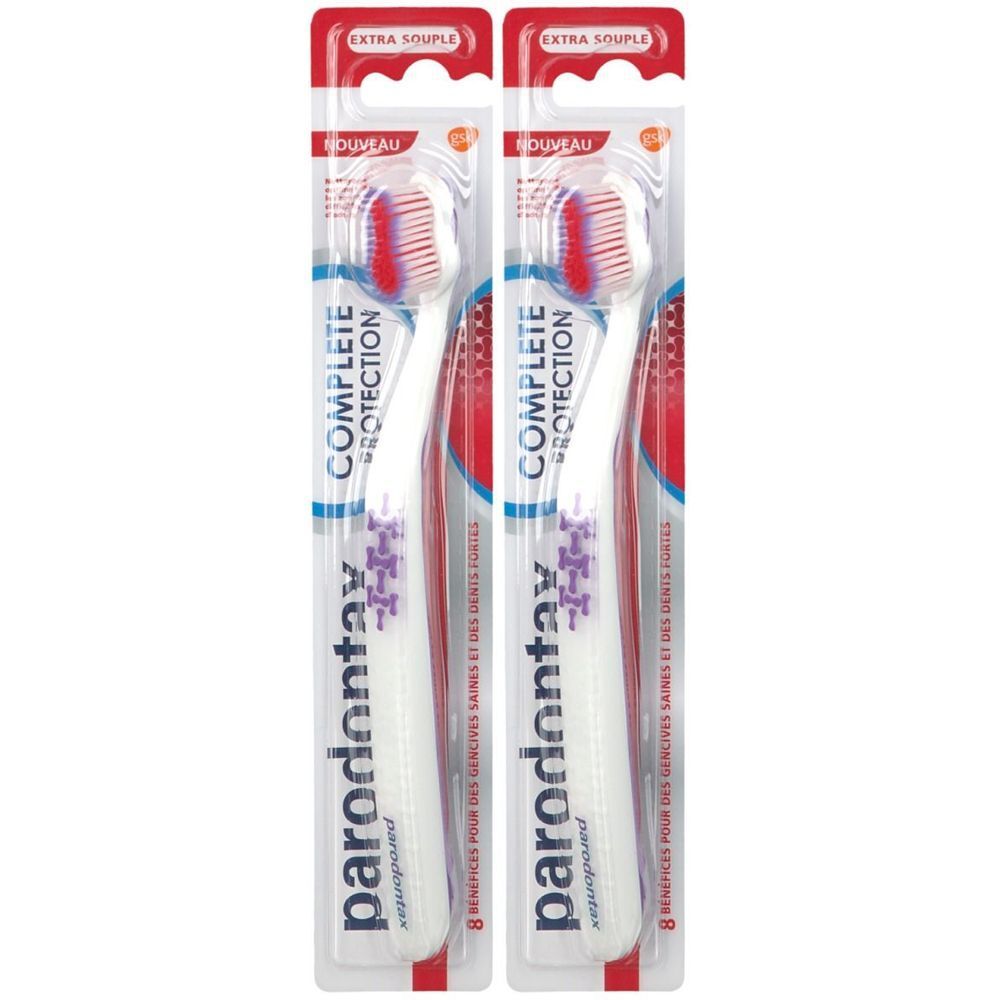 Deux brosses à dents emballées. Manches blancs, soies rouges et blanches. Marque : parodontax. Inscription : Complete Protection, Extra Souple.