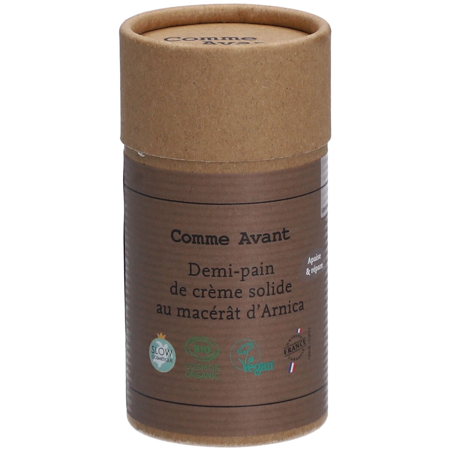 Zylindrische Verpackung von Comme Avant Creme. Aufschrift: Demi-pain de crème solide au macérât d'Arnica. Mit Bio-Siegeln.