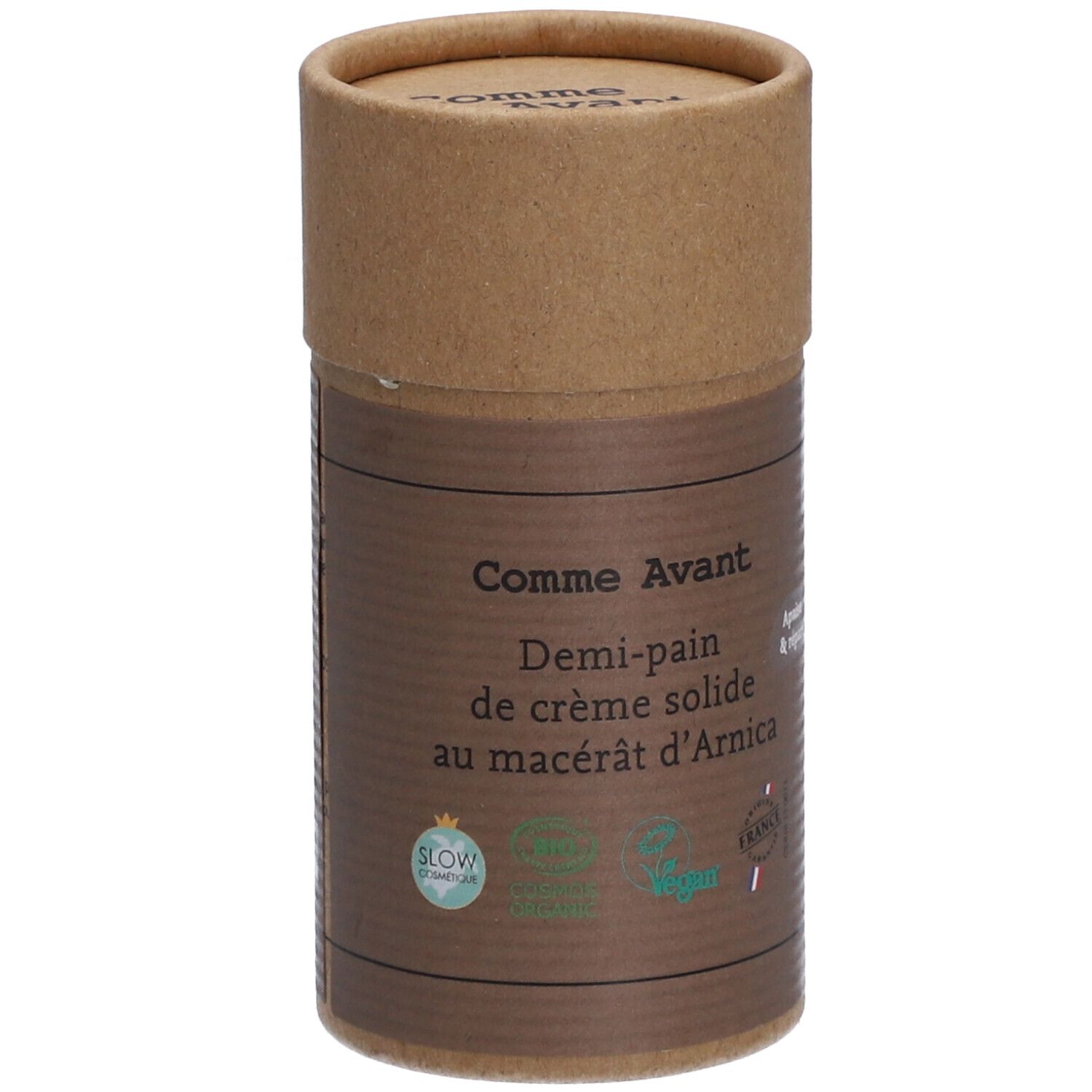 Zylindrische Verpackung von Comme Avant Creme. Aufschrift: Demi-pain de crème solide au macérât d'Arnica. Mit Bio-Siegeln.