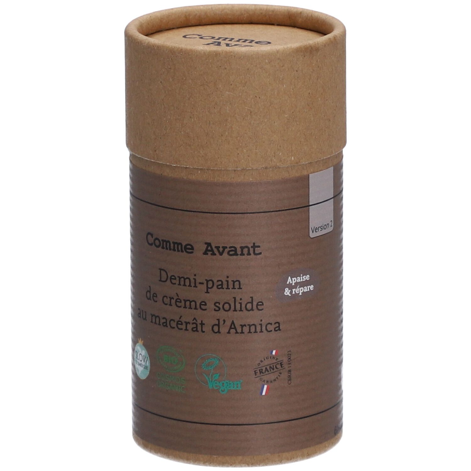 Zylindrische Verpackung von Comme Avant Creme. Aufschrift: Demi-pain de crème solide au macérât d'Arnica. Mit Bio-Siegeln.