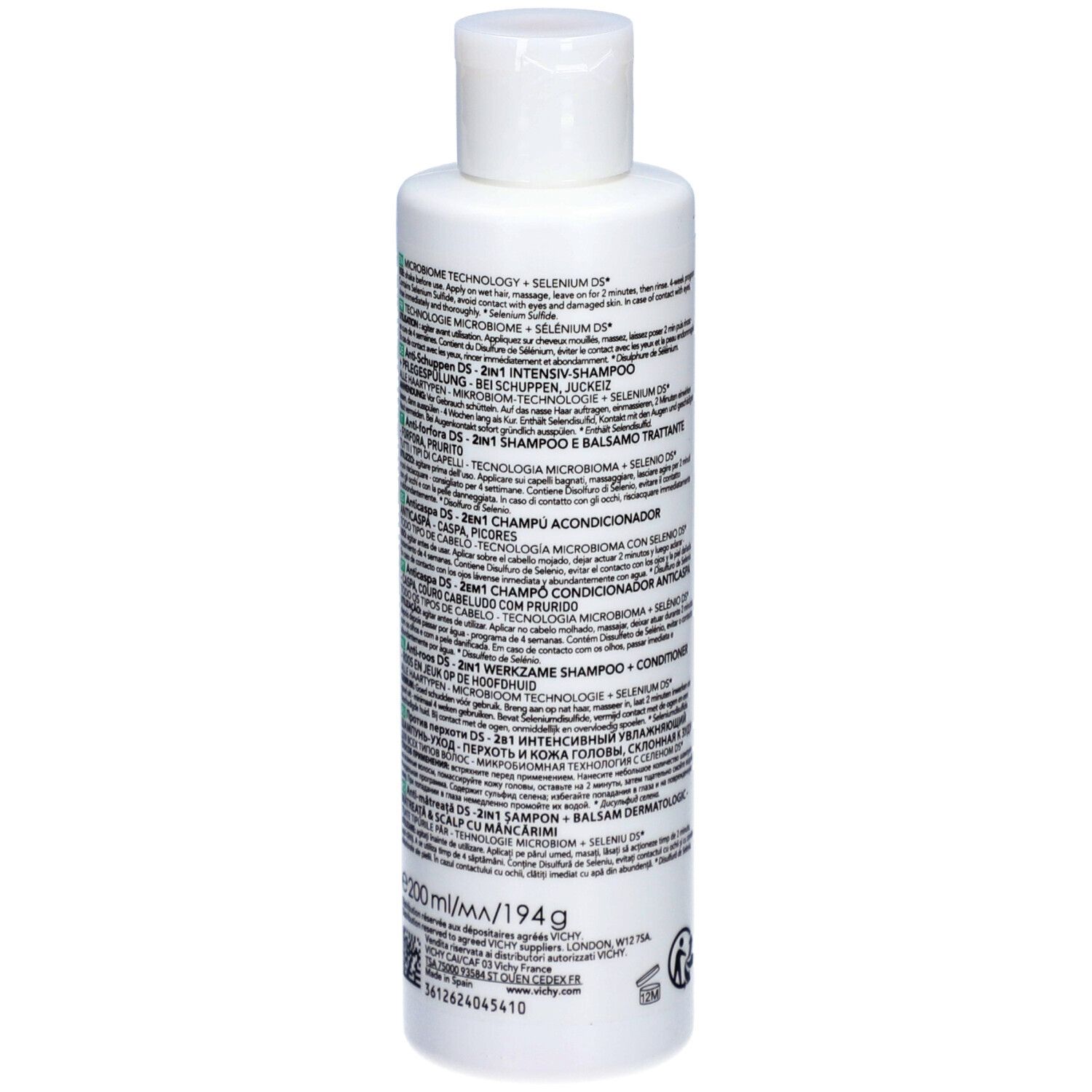 Rückseite der weißen Flasche. Text: DERCOS, Inhaltsstoffe, Gebrauchsanweisung. Grüner Bereich mit Text.