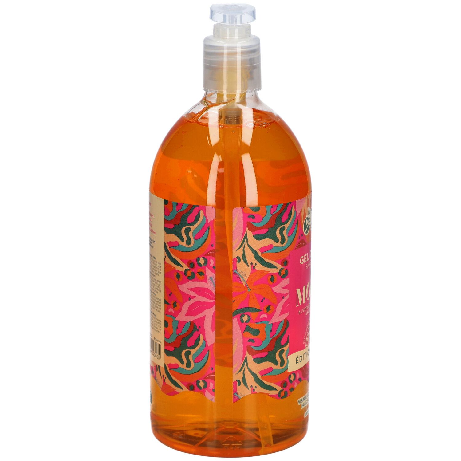 Flacon transparent de gel douche orange. Étiquette rose avec texte MONOÏ, Edition Limitée. Avec pompe.
