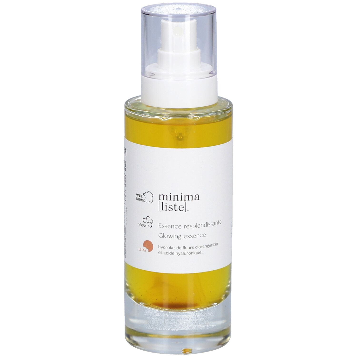 Glazen fles met gele vloeistof en verstuiver. Opschrift: minima liste. Essence resplendissante, Glowing essence.