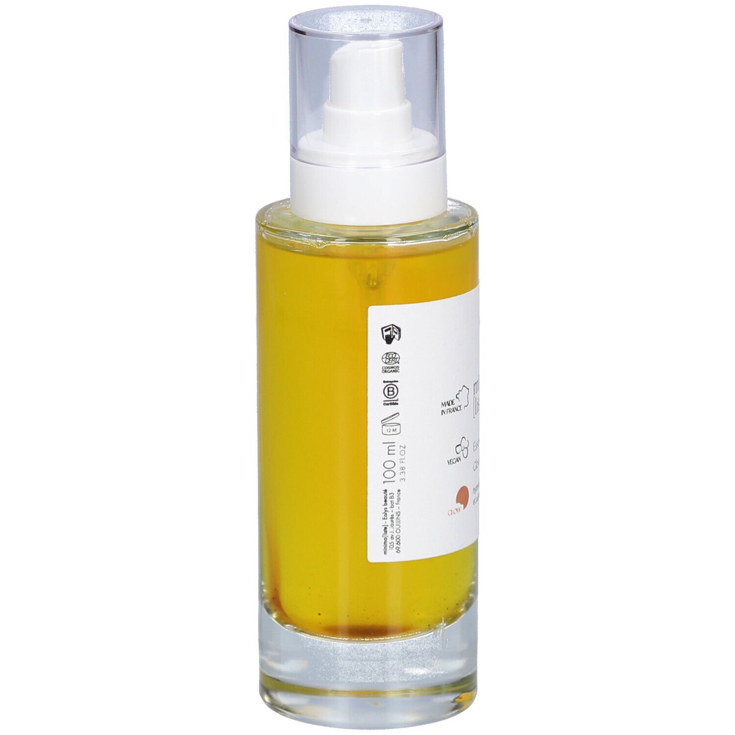 Glazen fles met gele vloeistof en verstuiver. Opschrift: minima liste. Essence resplendissante, Glowing essence. 100 ml.