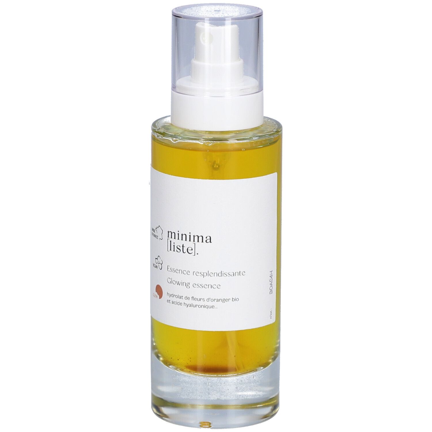 Glazen fles met gele vloeistof en verstuiver. Opschrift: minima liste. Essence resplendissante, Glowing essence.