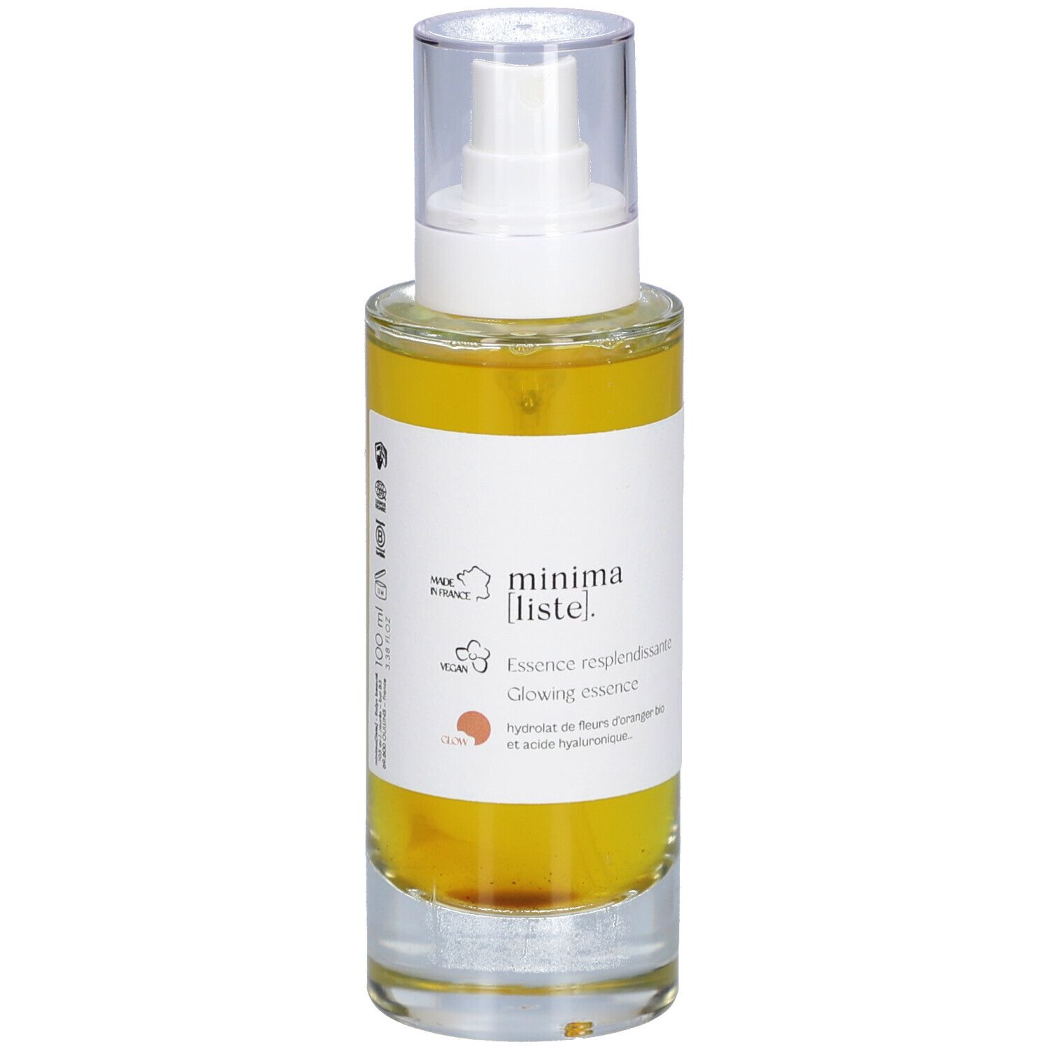 Glazen fles met gele vloeistof en verstuiver. Opschrift: minima liste. Essence resplendissante, Glowing essence.