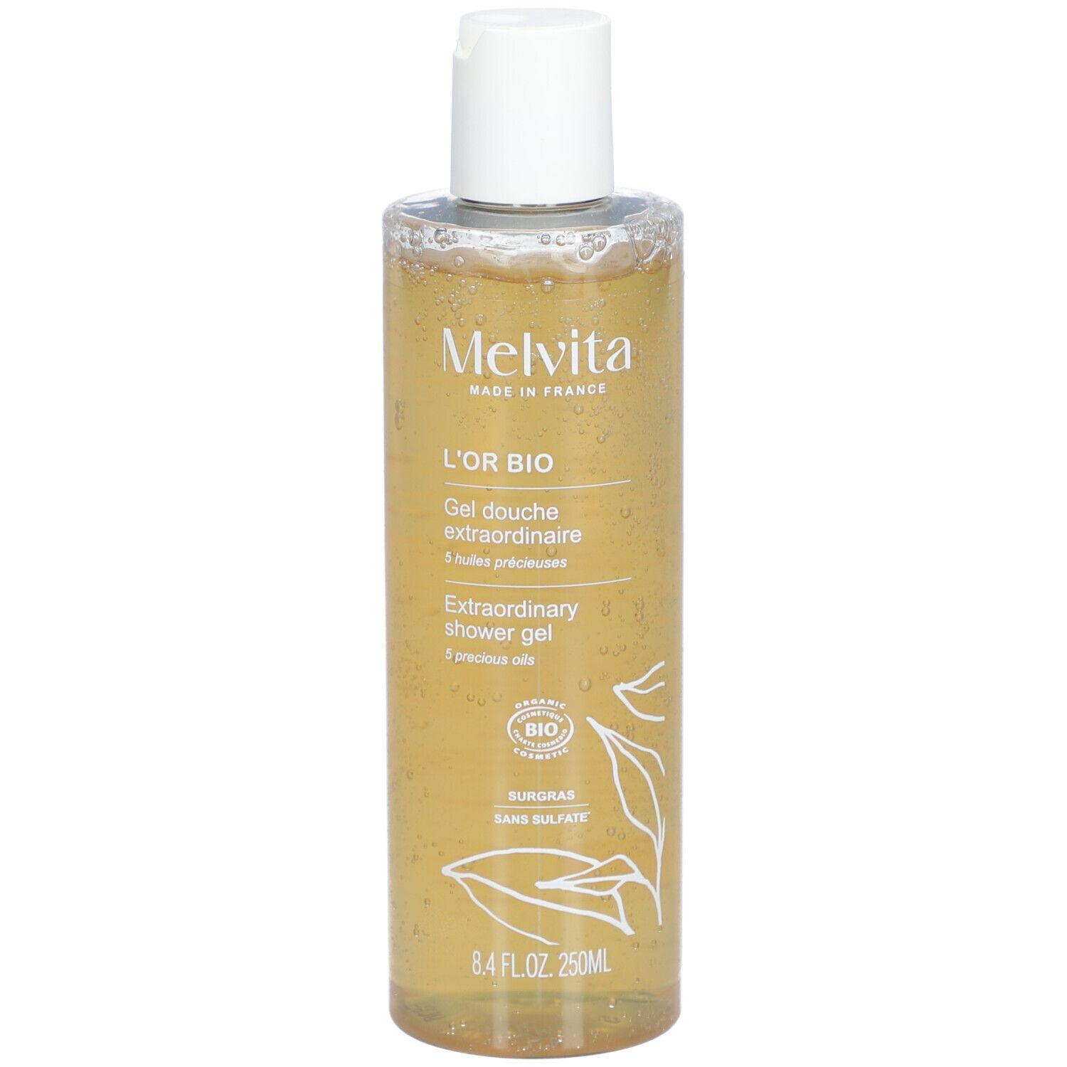 Melvita L'Or Bio Gel Douche Extraordinaire. Transparente Flasche mit gelbem Inhalt. Weißer Deckel. Bio-Siegel.