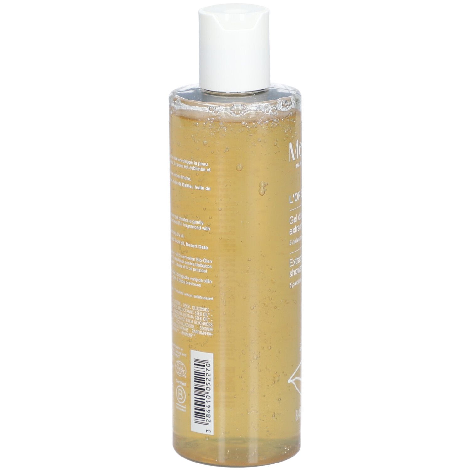 Rückseite der Melvita L'Or Bio Gel Douche Extraordinaire Flasche. Text und Barcode auf transparentem Behälter.