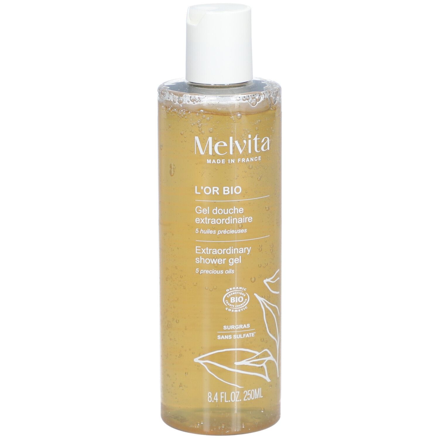 Melvita L'Or Bio Gel Douche Extraordinaire. Transparente Flasche mit gelbem Inhalt. Weißer Deckel. Bio-Siegel.