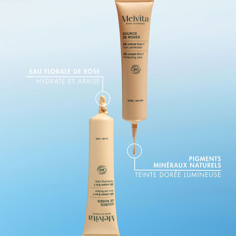 Zwei BB Cream Tuben. Tropfen. Natürliche Mineralpigmente. Goldene, leuchtende Farbe. Blauer Hintergrund.