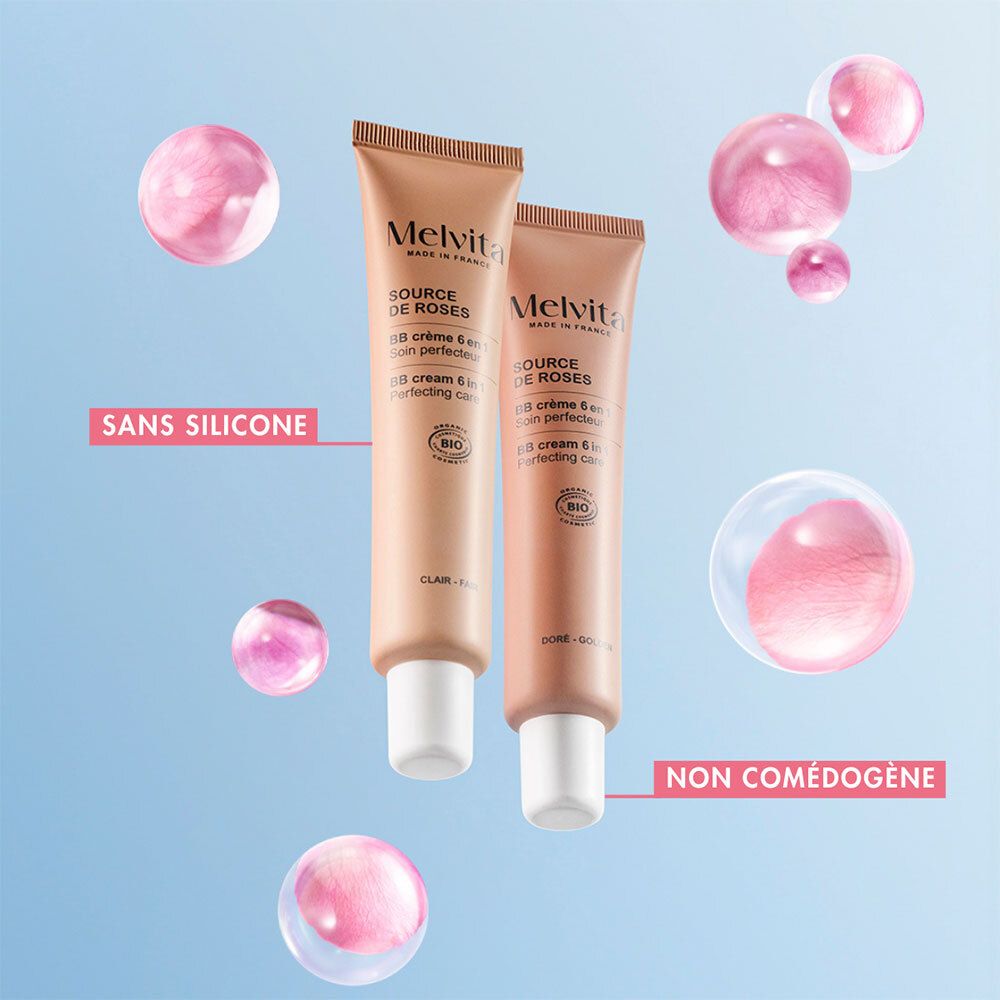 Zwei BB Cream Tuben. Ohne Silikon. Nicht komedogen. Rosa Blasen. Blauer Hintergrund.