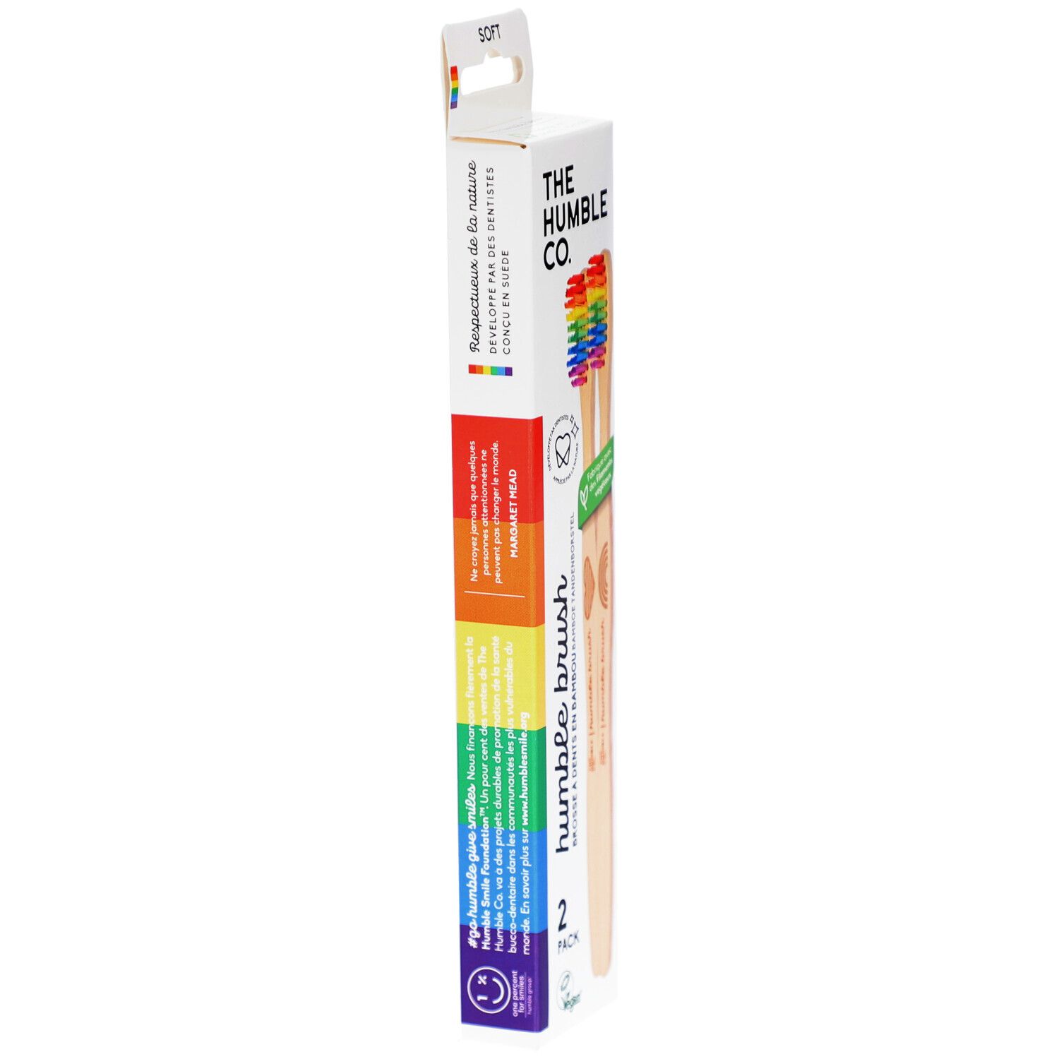 Schmale Verpackung mit zwei Zahnbürsten. Regenbogenfarbenes Design. Marke: The Humble Co. Aufschrift: Humble Brush. Text in Französisch.