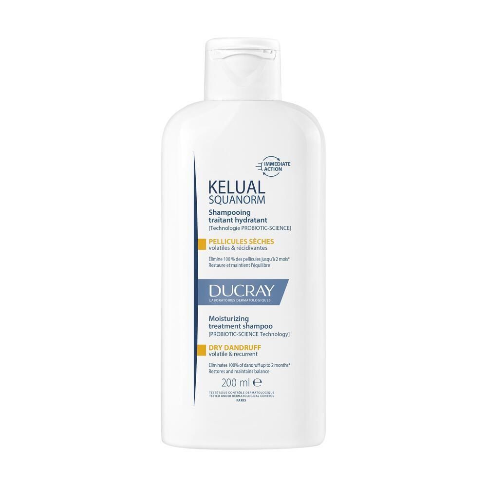 Flacon blanc de shampooing. Inscription: KELUAL SQUANORM, Ducray. Pour pellicules sèches. 200 ml.