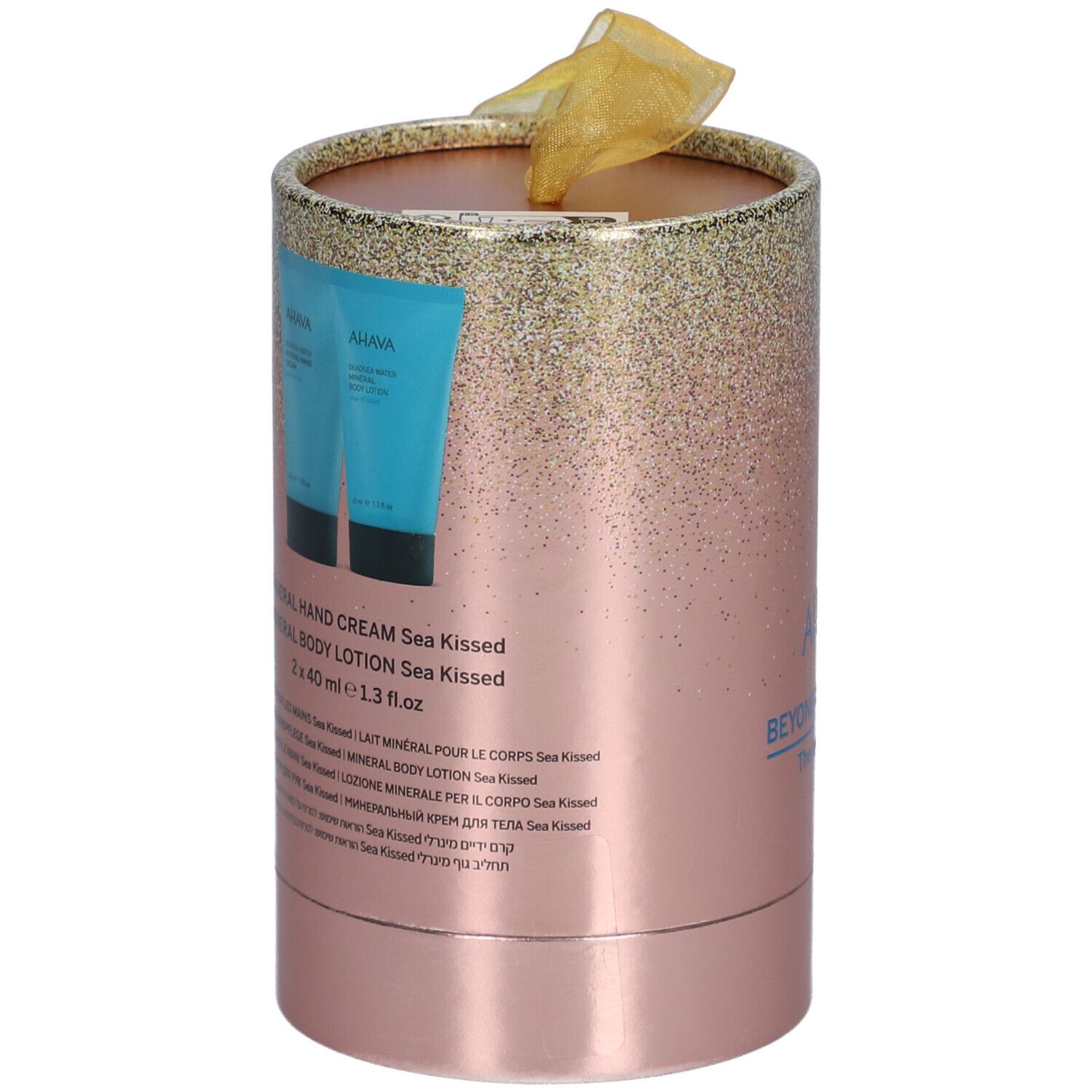 Emballage cadeau cylindrique rose avec dégradé doré. Deux tubes bleus. Texte: Mineral Hand Cream, Body Lotion. Ruban doré.