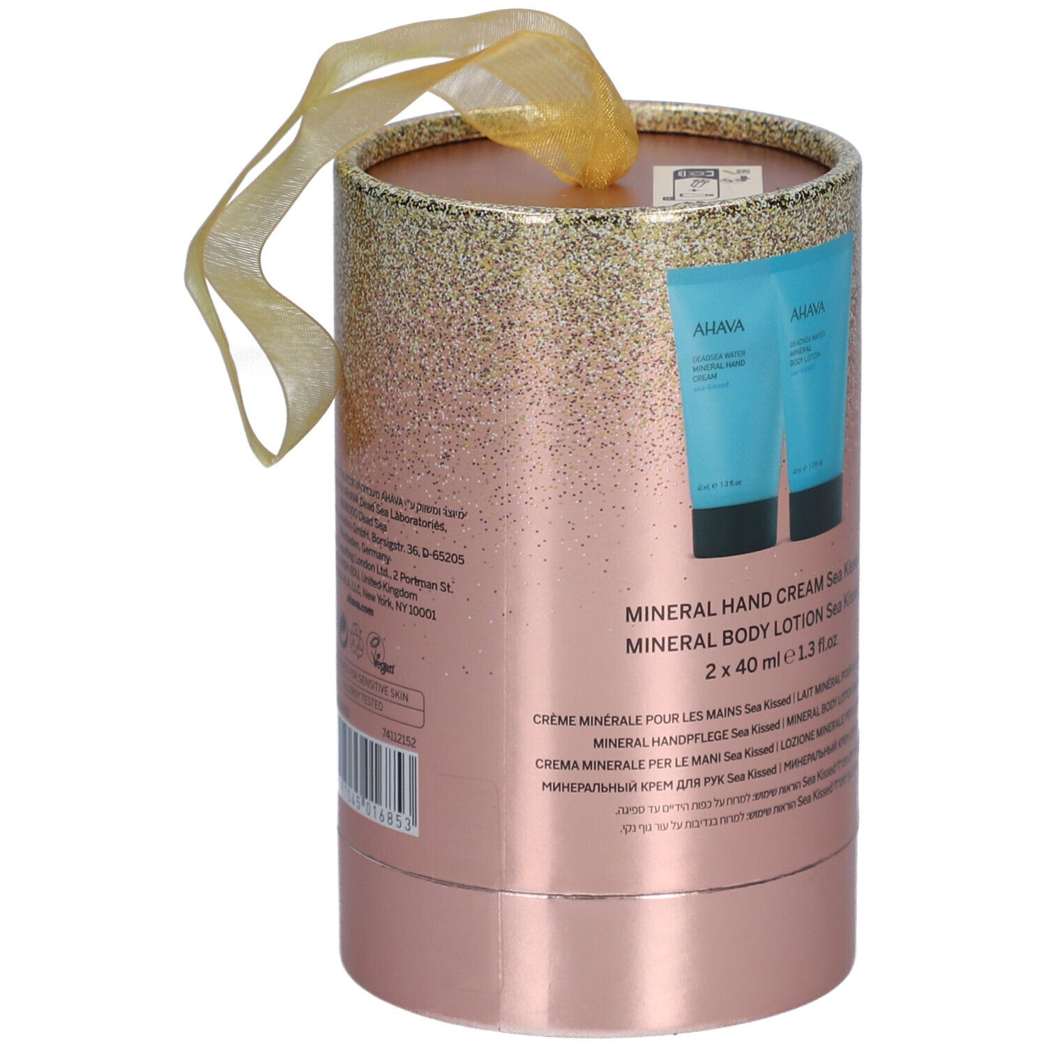 Emballage cadeau cylindrique rose avec dégradé doré. Texte: Mineral Hand Cream, Body Lotion. Ruban doré.