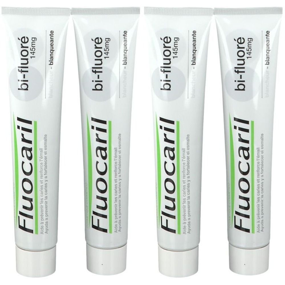 Quatre tubes de dentifrice blancs. Inscription: Fluocaril bi-fluoré 145mg. Texte en français et espagnol. Aspect blanchissant.